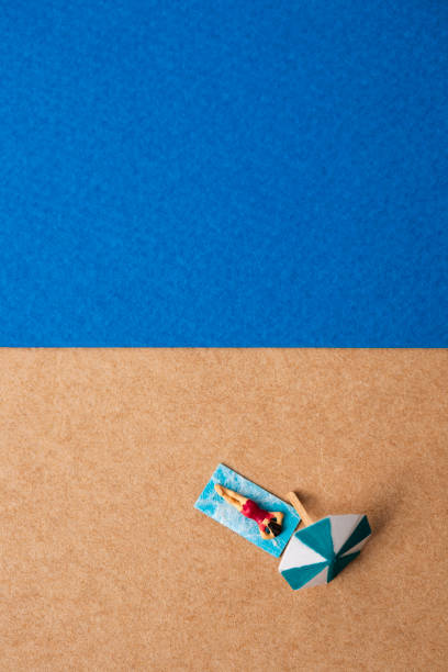 istock miniature woman in the summer beach 1158145522