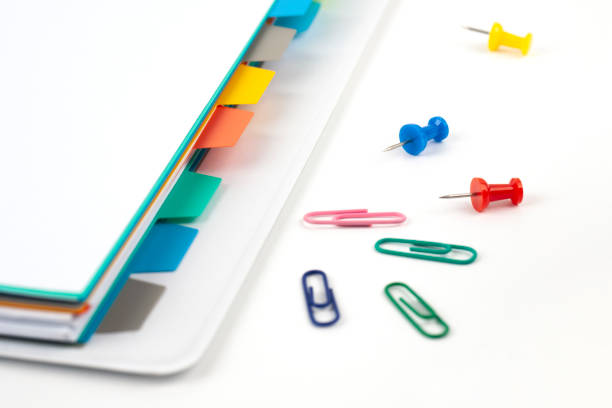 istock pile of documents with colorful clips on white background 1158145536
