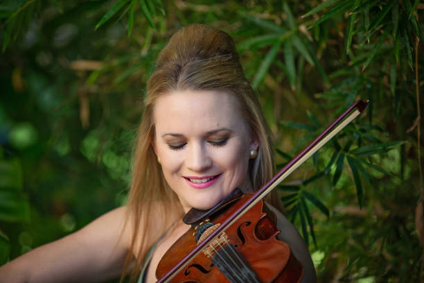 istock Beautiful Woman Playing Violin 1158148122