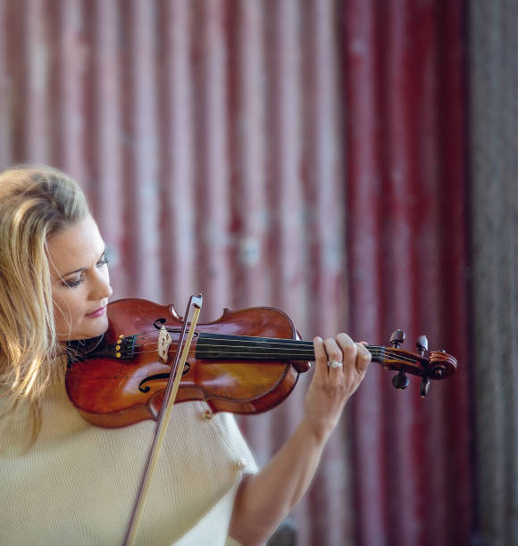 istock Beautiful Woman Playing Violin 1158148125