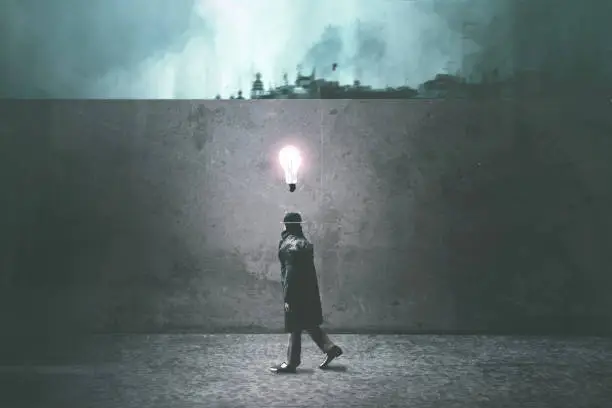 Photo of inspired dark man walking in the night with an idea over his head
