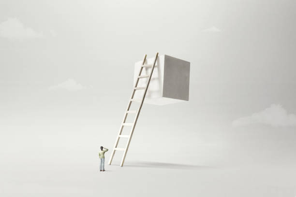 istock man observing white solid cube suspended in the air, surreal concept 1158149432