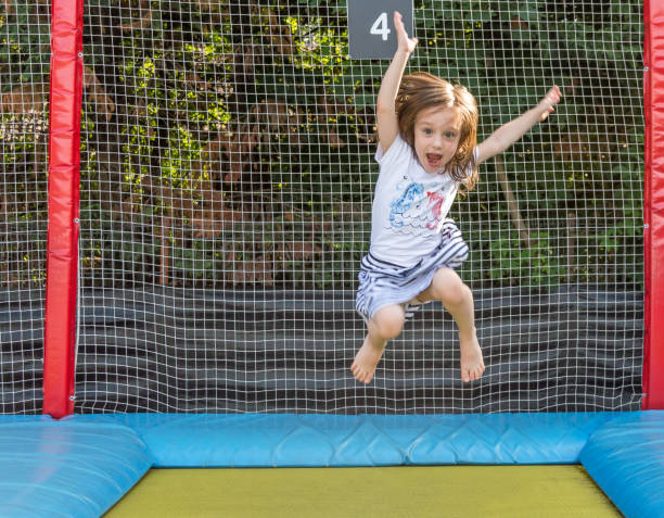 istock Little child enjoys jumping on trampolin 1158149445