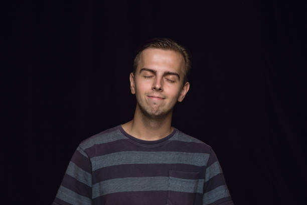 istock Close up portrait of young man isolated on black studio background 1158149451
