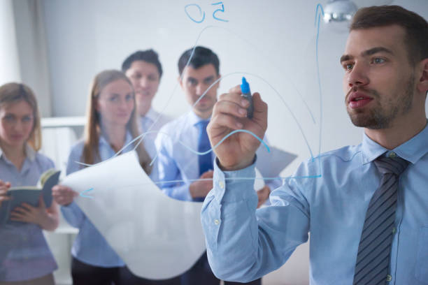istock Businessman explaining scheme to colleagues 1158149513