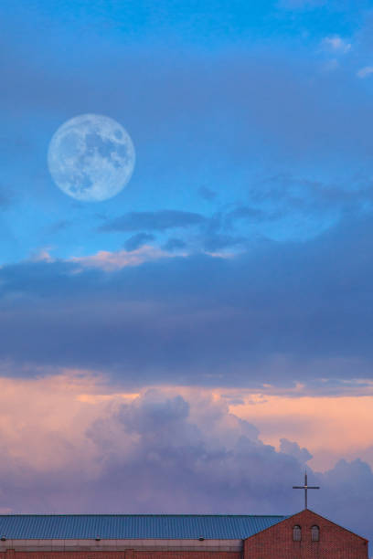istock Moonrise over the church roof 1158151017