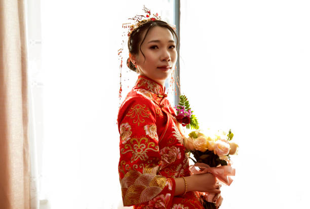 istock Hand holding Asian bride holding flowers 1158151255