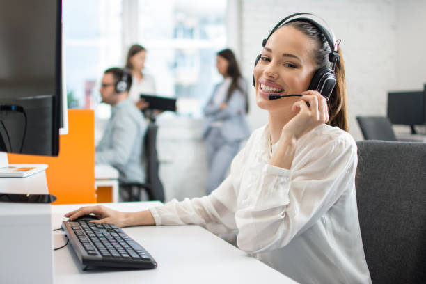 istock Young friendly operator woman agent with headsets working in a call centre. 1158152496