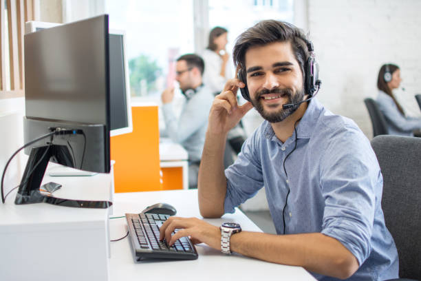 istock Portrait of handsome male customer service representative, call centre worker, agent, operator, support staff speaking with head set in modern office. 1158152511