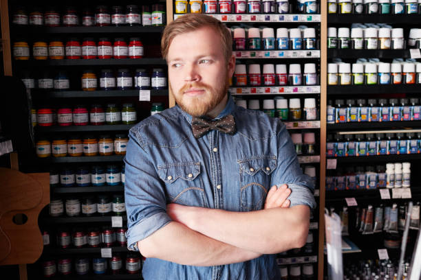 istock Confident seller in art store looking away 1158154788