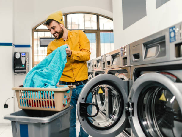 istock Man putting the laundry in the machine 1158156571