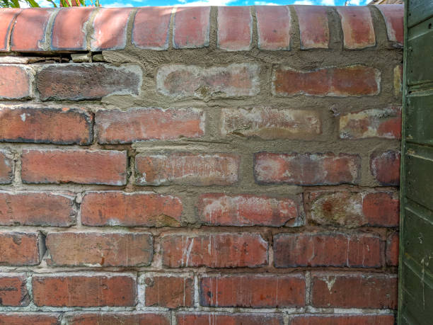 istock Garden red brick wall with old and new mortar. 1158156601
