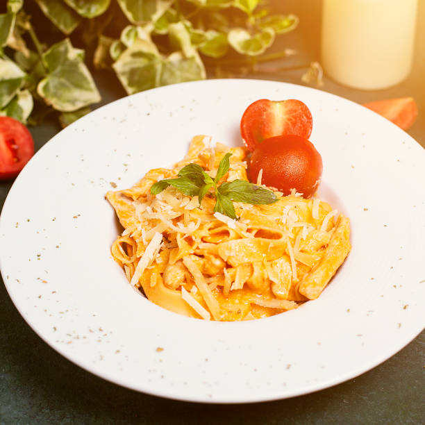 istock Pasta in tomato sauce with chopped parmesan , tomato and basilic. 1158156646