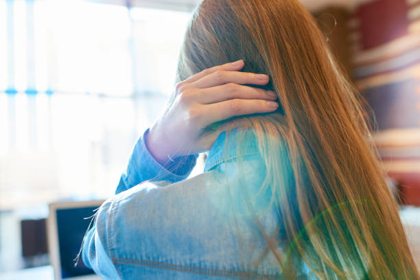 istock Anonymous female touching hair in cafe 1158156817
