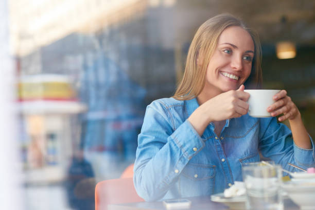 istock Cheerful lady enjoying beverage in cafe 1158156834