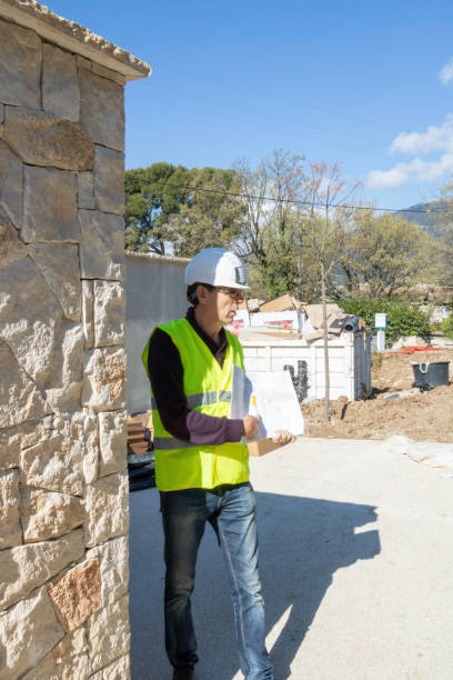 istock Teacher in the building sector, showing a plan to his trainees, during a site visit 1158156955