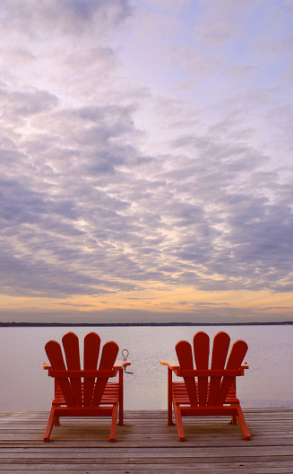 Red Adirondack Chairs on pier of Ross Barnett Resevior. Jackson, MS