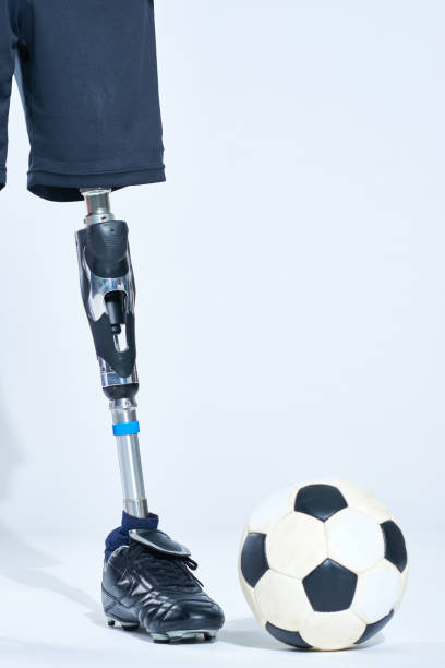 istock Crop athlete with leg prosthesis near ball 1158157752