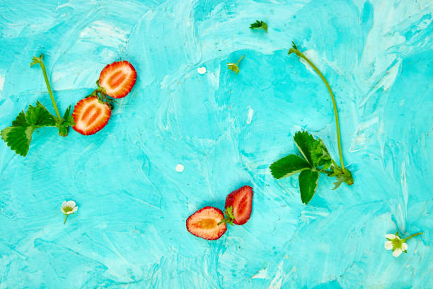 istock Flat lay composition with strawberries on a blue background. Colorful bright pattern made of strawberries and leaves.  Fruit frame. Summer concept. Flat lay, top view. Copy space. 1158158398