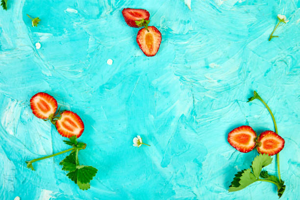 istock Flat lay composition with strawberries on a blue background. Colorful bright pattern made of strawberries and leaves.  Fruit frame. Summer concept. Flat lay, top view. Copy space. 1158158405