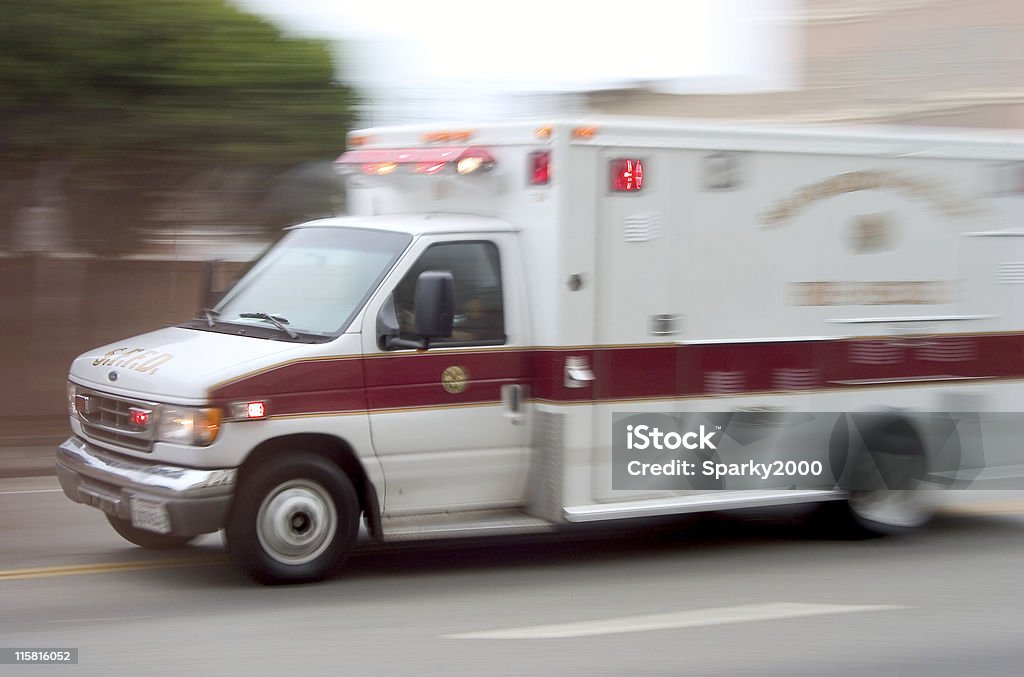 Ambulance #1 An ambulance blazes by, it's sirens whaling.  An intensional camera blur gives a feeling of a rushed tension to the scene. Ambulance Stock Photo