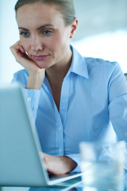 istock Focused female entrepreneur browsing laptop 1158161040