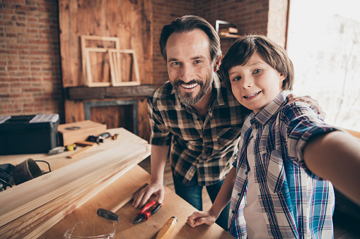 Self-portrait of two nice person cheerful cheery woodworkers handymen generation, creating construction at school course class studio modern loft industrial brick interior indoors