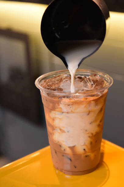 istock milk pour over glass of ice coffee 1158161163