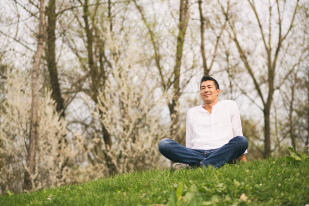 istock Japanese man sitting in nature 1158161208