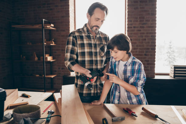 istock Portrait of two nice person focused concentrated woodworkers sharing generation experience skills at training course class studio modern loft industrial brick interior indoors 1158161480
