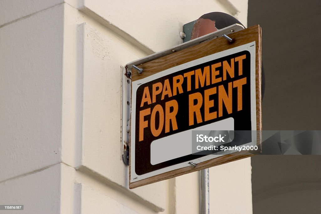 Apartment for Rent Sign A for rent sign on display on the side of a down town apartment building. Renting Stock Photo