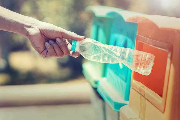 istock people hand holding garbage bottle plastic putting into recycle bin for cleaning 1158162339