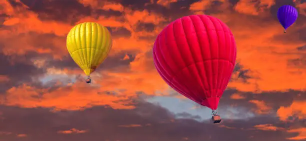 colorful (aeronautics) balloons fly in the sunset sky