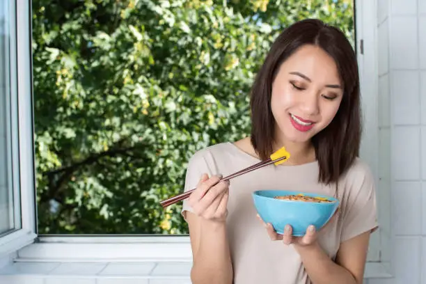 Young and Healthy Asian woman eating fruit