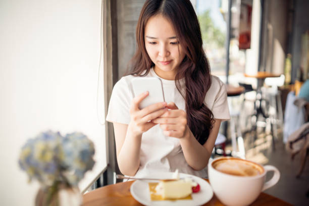 istock Asian girl using her smartphone 1158167728