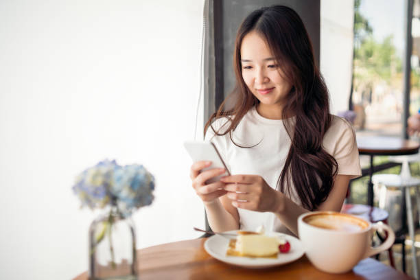 istock Young Chinese woman using her smartphone 1158167923