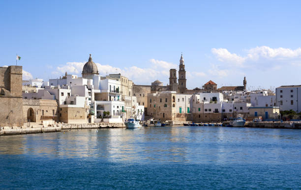 Monopoli skyline seen from the sea, Puglia Italy Waterfront with nautical vessels, towers and church cupolas bari photos stock pictures, royalty-free photos & images