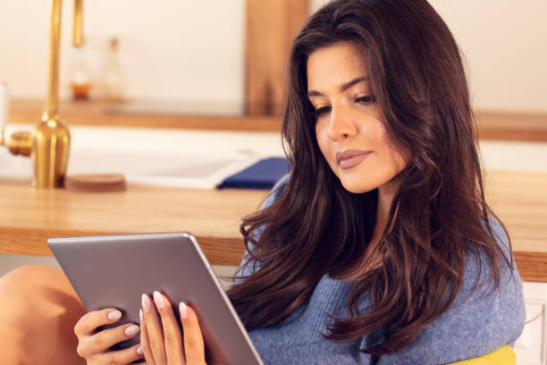 istock Attractive brunette girl with tablet. 1158170817