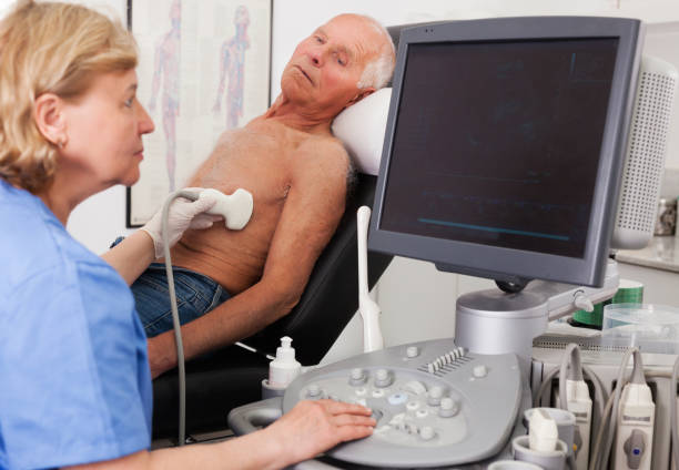 istock doctor examines a senior man  with ultrasonic  device 1158172223