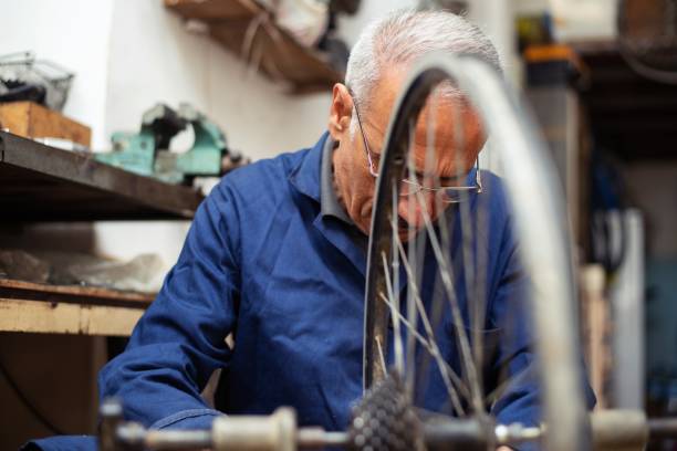 istock Bicycle mechanic working in his shop 1158172389