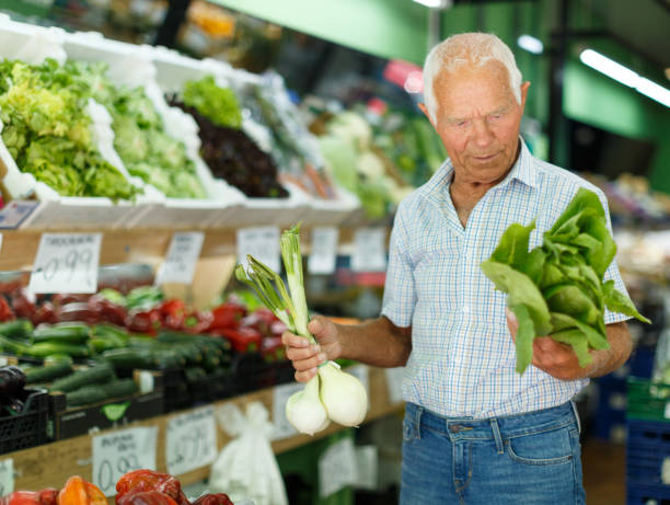 istock Elderly man looking for fresh vegetables 1158173767
