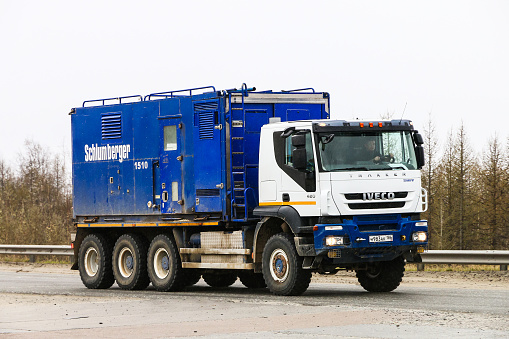 Novyy Urengoy, Russia - June 9, 2019: Schlumberger oil and gas service truck Iveco Trakker at the interurban road.
