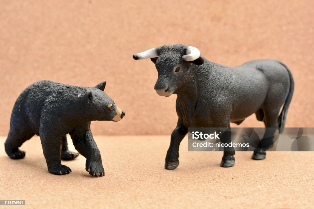 Bull Bear Confrontation Bull Bear Confrontation in a Stock Market Concept. Toy Stock Photo