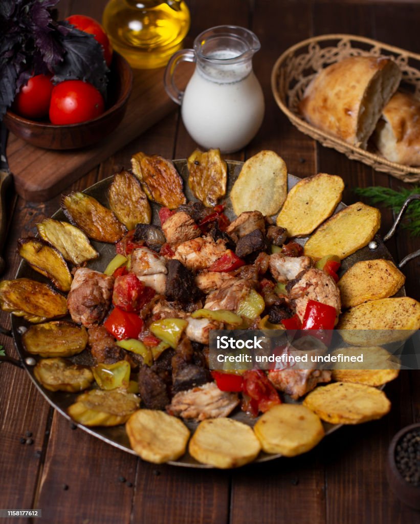 Sac ici, traditional Azerbaijani meal with grilled eggplant, potato slices, beef, chicken, lamp and color bell peppers. Sac ici, traditional Azerbaijani meal with grilled eggplant, potato slices, beef, chicken, lamp and color bell peppers. image Azerbaijan Stock Photo