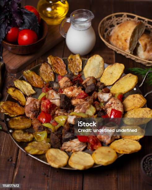 Sac Ici Traditional Azerbaijani Meal With Grilled Eggplant Potato Slices Beef Chicken Lamp And Color Bell Peppers Stock Photo - Download Image Now