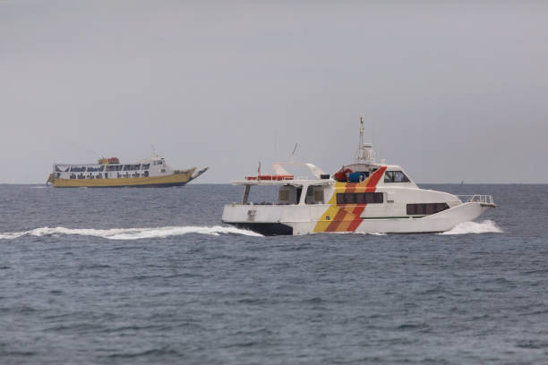 istock fast ferry and speed boat meet in the open sea 1158178301