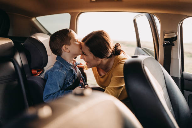 Where do you want to go? Pregnant mother preparing his son for travel in car family-van-driving stock pictures, royalty-free photos & images
