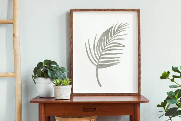 istock Stylish scandinavian room with design retro small table, mock up poster frame, elegant accessories, wooden ladder and beautiful plants in cozy pots. Minimalistic home decor. Gray background wall. 1158178848