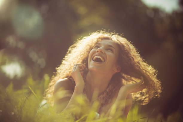 They are not more beautiful than a sincere smile. Woman in outdoors.