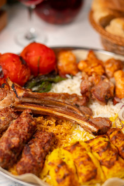 istock Beef, chicken kebab, bbq with roasted, grilled potatoes, tomatoes and served with rice. 1158180970